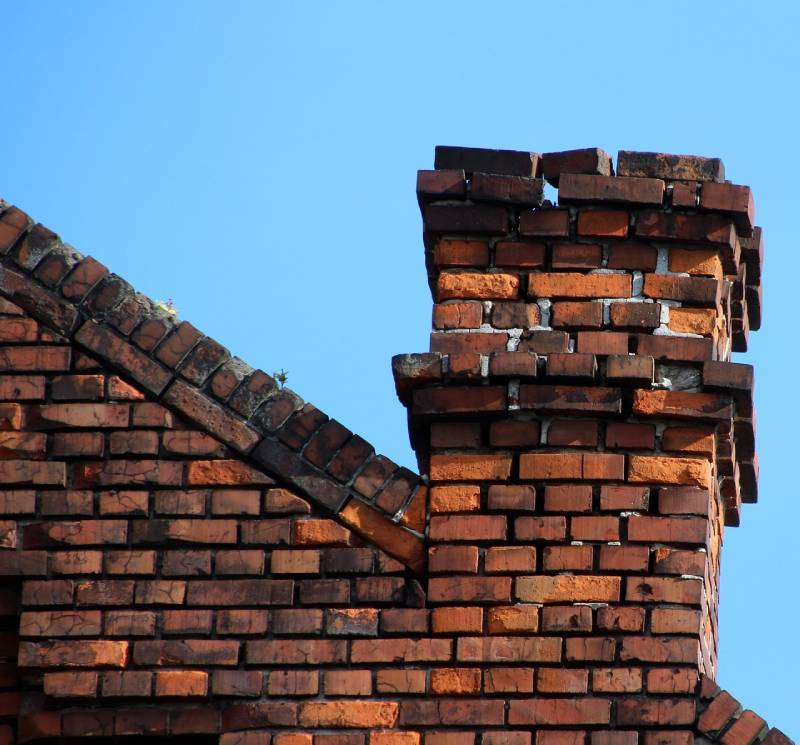 Damaged chimney on an Immokalee home showing cracks and missing mortar